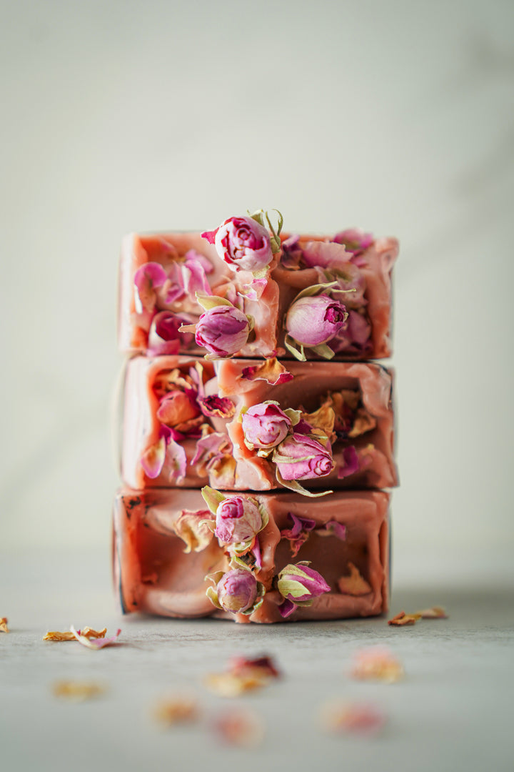 Stacked Wild Rose soap bars showing rose petal texture, handcrafted by Orange Blossom Collective