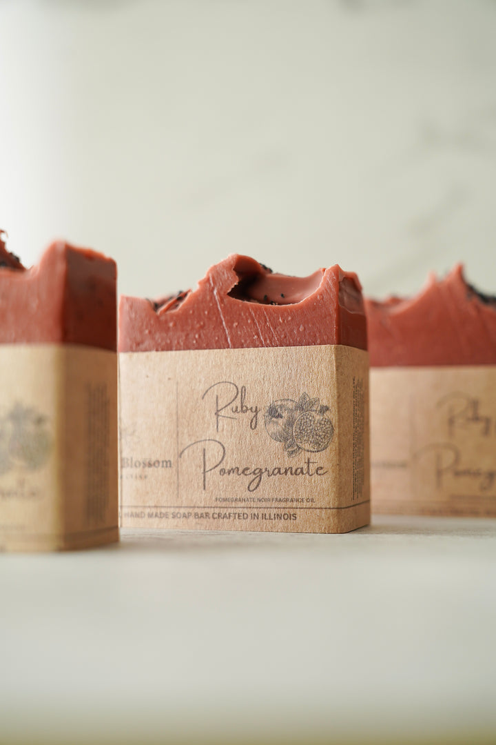 Fig & Pomegranate bar soap with a swirled terracotta top and kraft paper wrap, handcrafted by Orange Blossom Collective