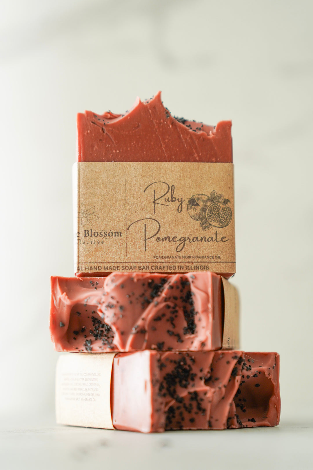 Stacked Fig & Pomegranate soap bars showing marbled red and pink swirl texture