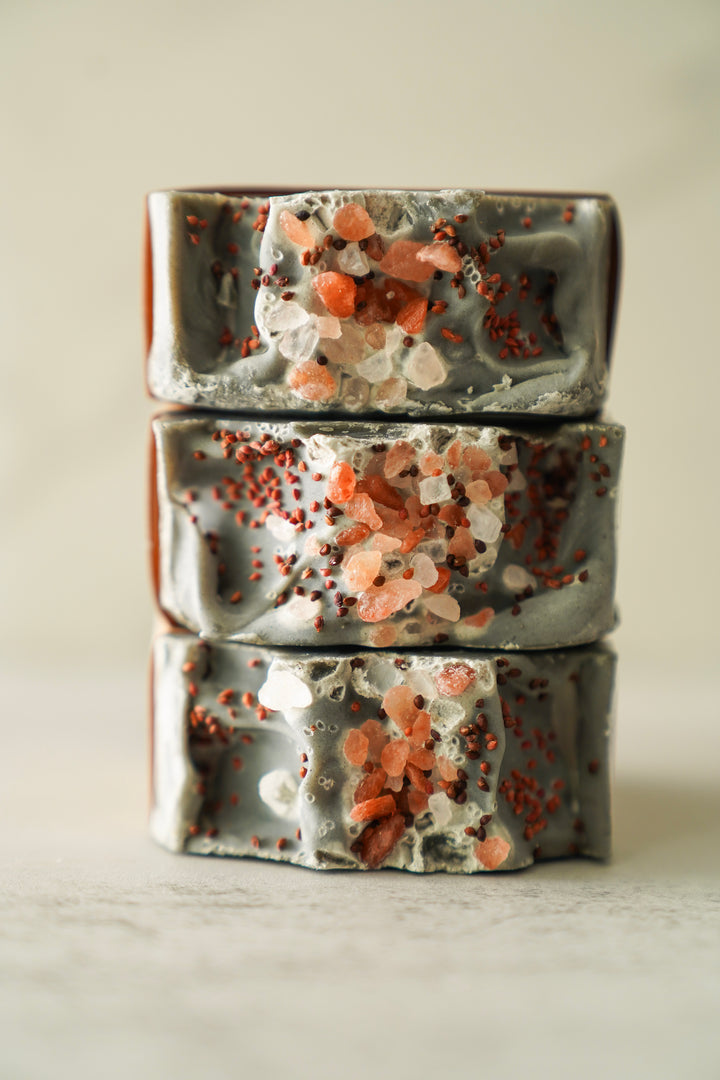 Three Obsidian Grove bars stacked, dark charcoal tops with speckled texture