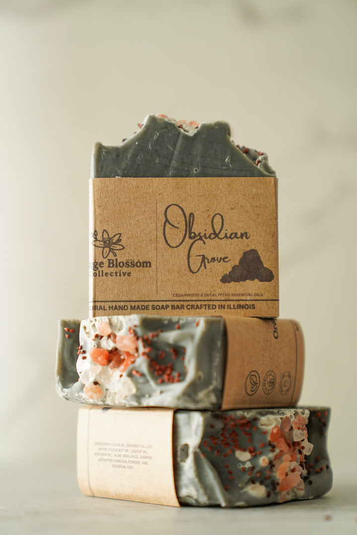 Obsidian Grove soap bar stacked with dark charcoal top exposed, kraft label visible