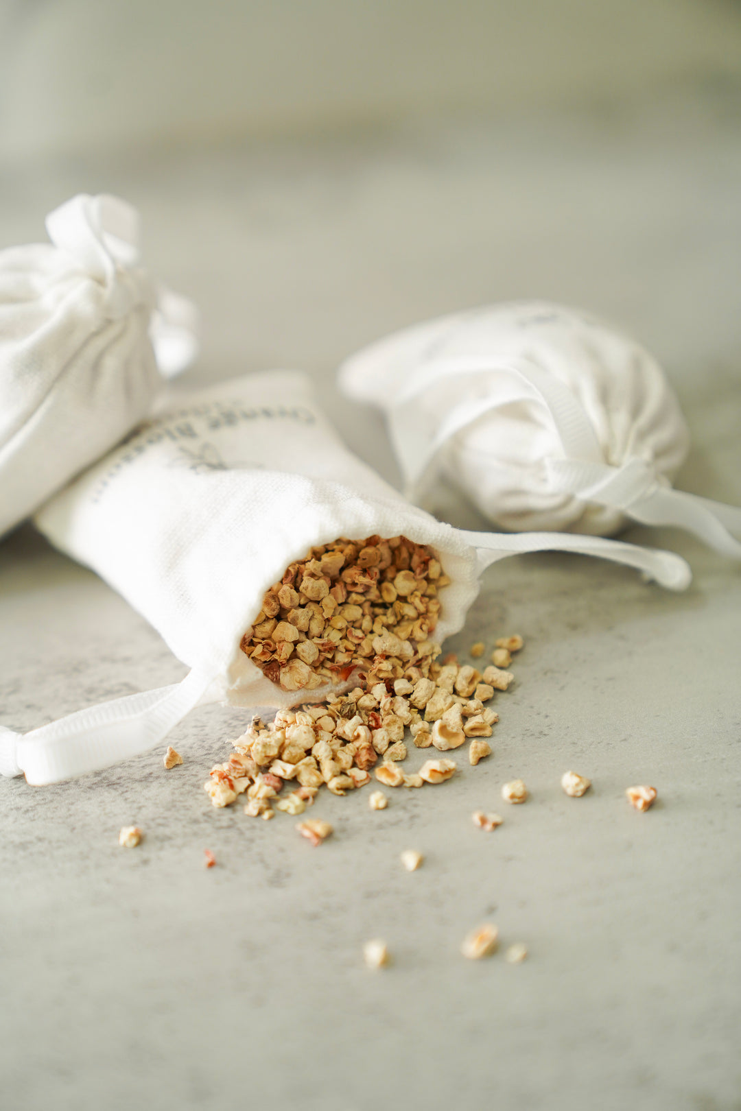 Orange Blossom Collective scented sachet tipped over showing dried botanical fragrance filling spilled out