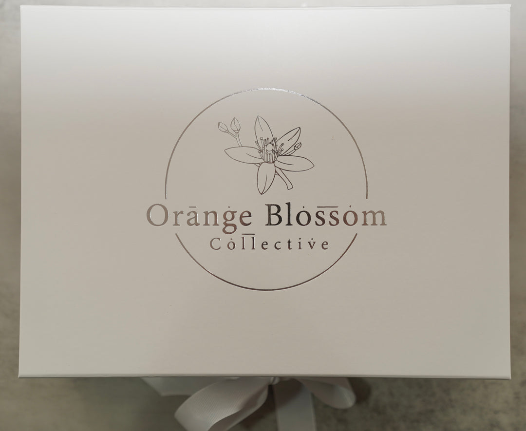 White Orange Blossom Collective gift box with silver foil logo and ribbon