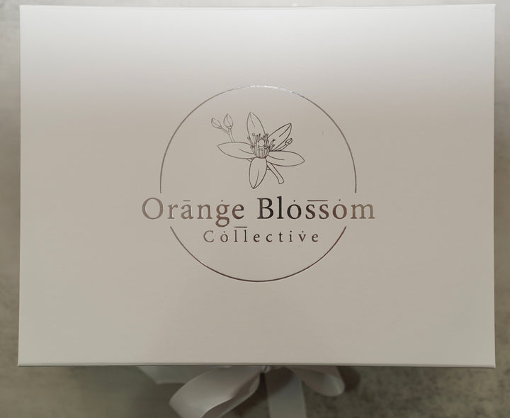 White Orange Blossom Collective gift box with silver foil logo and ribbon